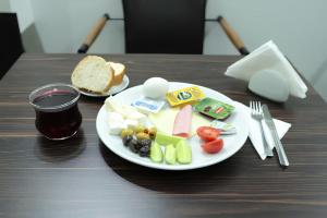 a plate of food with cheese and vegetables on a table at HOTEL GLOBAL 2022 in Istanbul