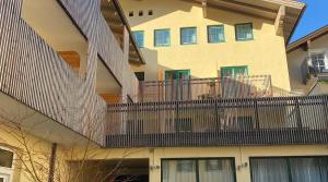 an apartment building with a balcony with a fence at Econnomy Adler in Golling an der Salzach