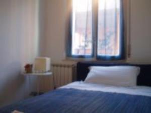 a bedroom with a bed and two windows at Bed And Roses in Montesilvano