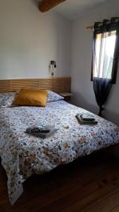 a bedroom with a bed with a comforter on it at L'oustalet du Luberon in Cadenet