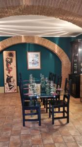 a dining room with a glass table and chairs at Podere Orto Wine Country House in Trevinano