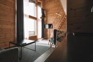 a living room with a table and a staircase at Star Arctic Hotel & Activities in Saariselka