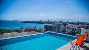 a swimming pool on a balcony with a view of the water at Seaview SS palm terrace serviced apt-nyali in Mombasa
