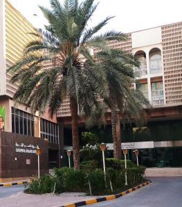 a palm tree in front of a building at OrientalPalace Hotel in Manama