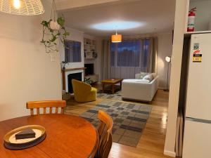 a kitchen and living room with a table and chairs at Tyne above Town in Oamaru