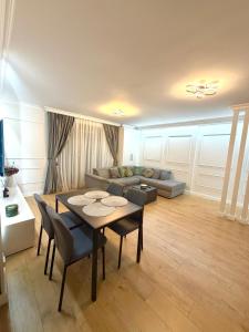 a living room with a table and a couch at Acasa Concept in Arad