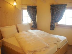 En eller flere senge i et værelse på Armonia Livigno Appartamenti