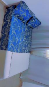a blue and white pillow sitting on top of a wall at A & A Apartments in Serekunda