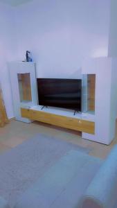 a living room with a large flat screen tv at A & A Apartments in Serekunda