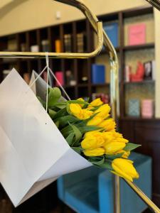 a bouquet of yellow tulips on a rack at Hotel Jelgava in Jelgava
