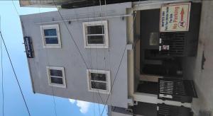 a building with windows and a sign on it at Hotel O White Inn in Chennai +23 photos
