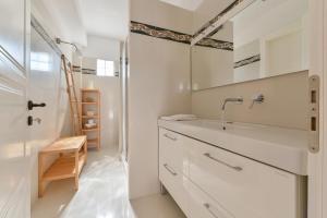 a white bathroom with a sink and a mirror at Citron, Parga Center Residence in Parga