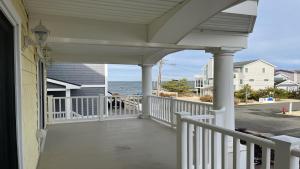 a porch of a house with a view of the ocean at Bayside Home With 4 Bedrooms And Elevator in North Beach Haven