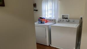 a laundry room with a washer and dryer at Bayside Home With 4 Bedrooms And Elevator in North Beach Haven +8 photos