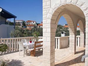 a patio with a table and chairs on a balcony at Apartment Marina in Slatine