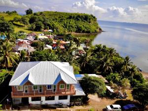 an aerial view of a house next to the ocean at Arriyus Apartelle in Maya +11 photos