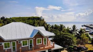 a house with a view of the ocean at Arriyus Apartelle in Maya