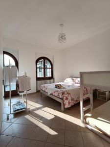 a bedroom with two beds and a window at La Casa del Merlo in Rodello