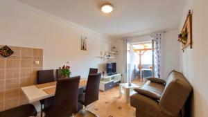 a living room with a table and chairs and a dining room at Apartmani Daria in Medulin