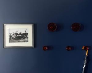 a blue wall with a picture and a baseball bat at Hotel Eden Palace au Lac in Montreux