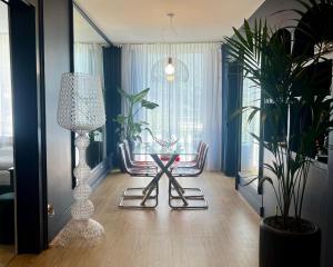 a living room with a table and chairs and a lamp at Hotel Eden Palace au Lac in Montreux