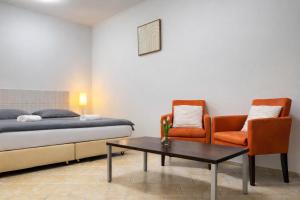 a bedroom with a bed and a table and a chair at Symbiola River Apartments in Děčín