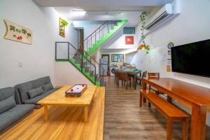 a living room with a couch and a table at FuqianRED in Tainan