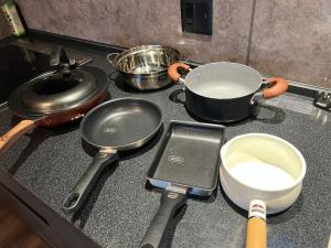 a stove top with pots and pans on it at Anbo-ing in Yakushima +10 photos