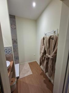 a bathroom with towels hanging on a towel rack at Le Ségusiave SPA in Feurs