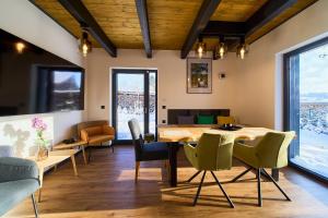 a dining room with a table and chairs at Apartmány U Kovárny in Horní Blatná