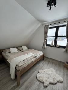 a bedroom with a bed and a large window at Chata Barvinok in Litmanová +18 photos