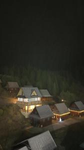 a group of houses at night with lights at Chata Barvinok in Litmanová