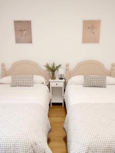 two beds sitting next to each other in a room at Hoya del Agua Casa Rural in Casas de Haro +45 photos