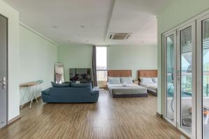 a living room with a blue couch and a bed at SETAPAK CENTRAL KUALA LUMPUR - By ALOHA in Kuala Lumpur +43 photos