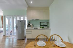 a kitchen with a table and chairs and a refrigerator at SETAPAK CENTRAL KUALA LUMPUR - By ALOHA in Kuala Lumpur
