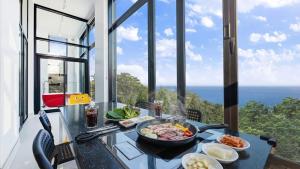 a table with food on it with a view of the ocean at Goseong Belossi Ayajin Kids Poolvilla in Goseong