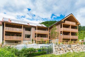 an image of a building with a stone wall at Genuss-Pension Herti in Übelbach