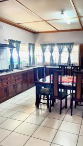 a kitchen with a table and chairs in a room at Pangolin self-catering accommodation in Windhoek