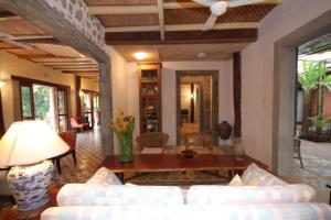 a living room with a couch and a table at Sala Prabang Hotel in Luang Prabang