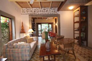 a living room with a couch and a table at Sala Prabang Hotel in Luang Prabang