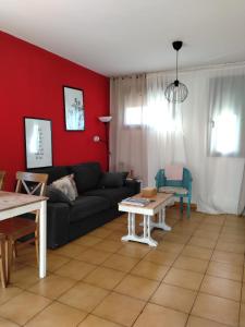 a living room with a black couch and a table at Apartamento Rural la Fontanina TRCC0087 Complejo la Fontanina in Mata de Alcántara