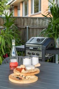 a picnic table with a grill and a plate of food at Wallace Cottage in Mount Gambier