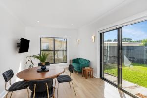 a living room with a table and chairs at Wallace Cottage in Mount Gambier