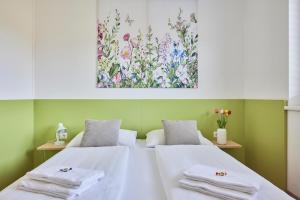 a bedroom with a bed with towels on it at I AM HOTELS Leoben in Leoben