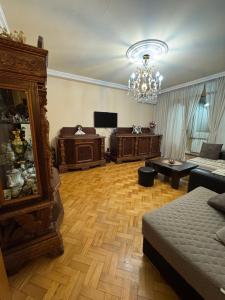 a living room with a couch and a chandelier at Apartment old Batumi in Batumi