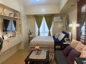 a small bedroom with a bed and a couch at Avida Tower 3 L21 staycation rm 117 in Iloilo City