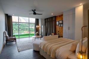 a hotel room with a large bed and a chair at Tibet Hotel in Skardu +34 photos