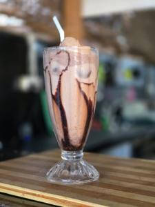 a drink in a glass sitting on a table at Secret Surf Hostel in Weligama