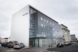 a large white building with a clock on the side of it at Storm Hotel by Keahotels in Reykjavík