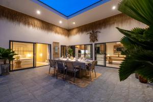 a dining room with a table and chairs at VILLA LOUMA - 4 Bedrooms with Private Pool in Koh Samui